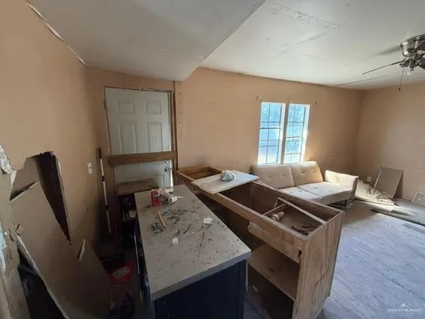 a view of a workspace with furniture and a window