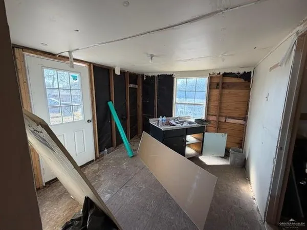 a living room with furniture stove and a large window