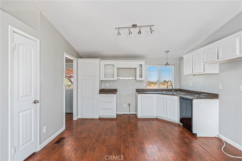 6320 Cholame Road Phelan, CA 92371 - Photo 12 of 33 a kitchen with granite countertop a refrigerator and a stove top oven