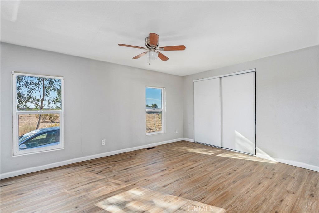 6320 Cholame Road Phelan, CA 92371 - Photo 16 of 33 a view of room with window ceiling fan and hardwood floor