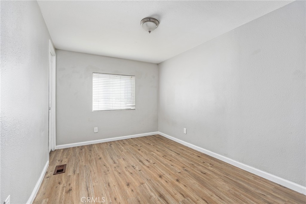 6320 Cholame Road Phelan, CA 92371 - Photo 20 of 33 an empty room with wooden floor and windows