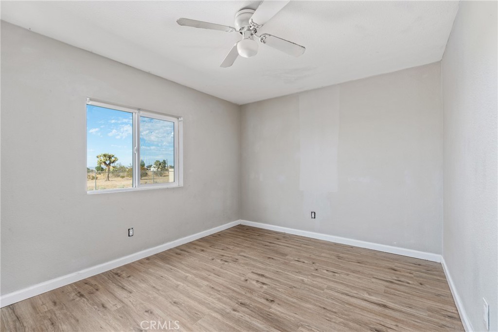 6320 Cholame Road Phelan, CA 92371 - Photo 22 of 33 wooden floor in an empty room with a window