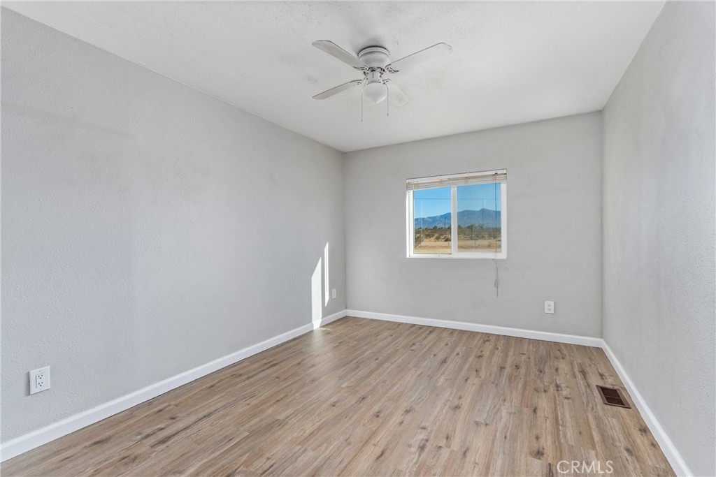 6320 Cholame Road Phelan, CA 92371 - Photo 28 of 33 wooden floor in an empty room with a window
