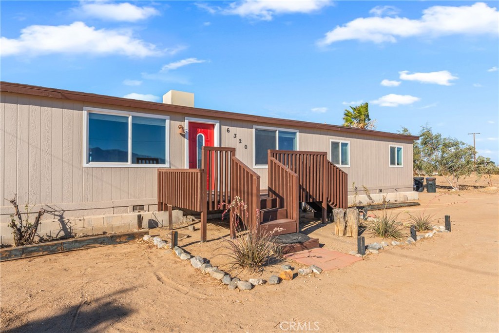 6320 Cholame Road Phelan, CA 92371 - Photo 5 of 33 a view of a house with wooden roof and sitting area
