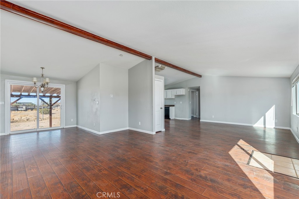 6320 Cholame Road Phelan, CA 92371 - Photo 9 of 33 a view of an empty room with wooden floor and a window