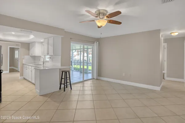 a view of kitchen with granite countertop cabinets and window
