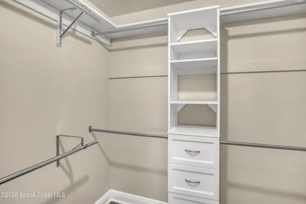 a bathroom with a granite countertop toilet sink and mirror