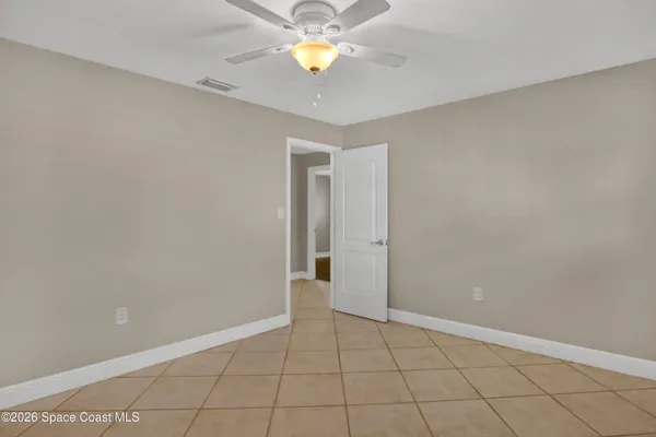 an empty room with a window and wooden floor