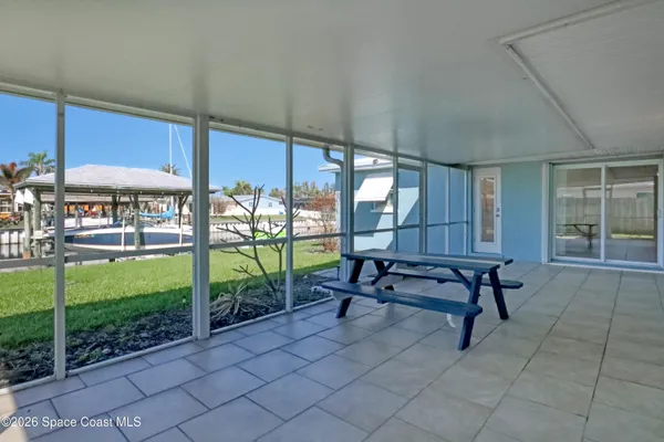 a view of a house with a yard and sitting area