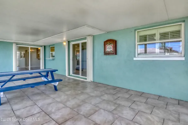 a view of a house with a yard and sitting area