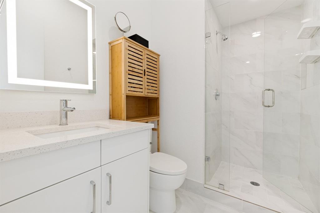 1952 Kearney Court Dallas, TX 75204 - Photo 18 of 24 a bathroom with a sink a toilet and shower