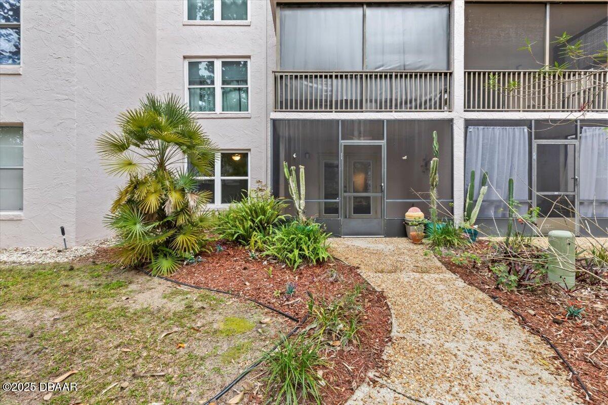 640 North Nova Road, Unit 114 Ormond Beach, FL 32174 - Photo 18 of 40 a front view of a house with a yard
