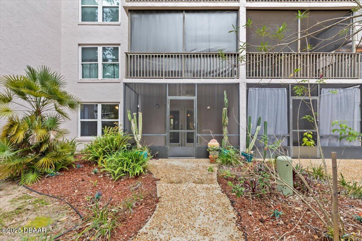 640 North Nova Road, Unit 114 Ormond Beach, FL 32174 - Photo 19 of 40 a view of a house with a yard and potted plants