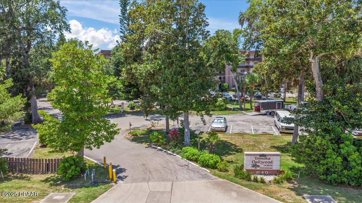 640 North Nova Road, Unit 114 Ormond Beach, FL 32174 - Photo 21 of 40 a view of a garden with plants and large trees
