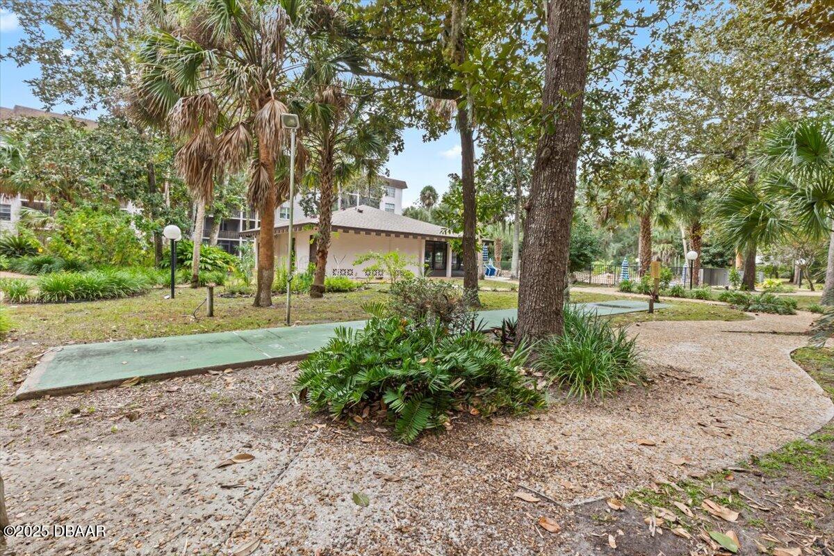 640 North Nova Road, Unit 114 Ormond Beach, FL 32174 - Photo 36 of 40 a front view of a house with a yard