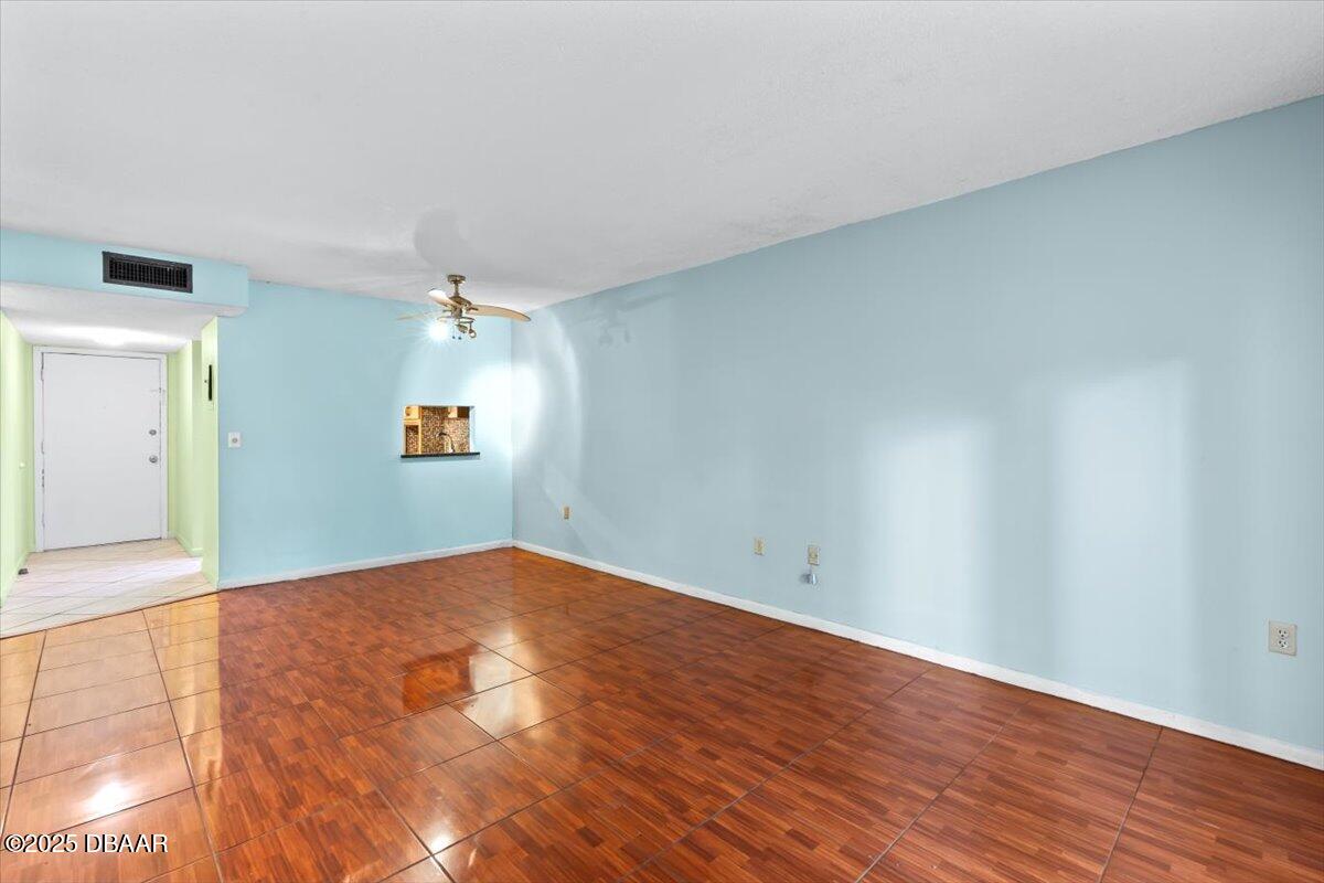 640 North Nova Road, Unit 114 Ormond Beach, FL 32174 - Photo 4 of 40 a view of empty room with wooden floor and fan