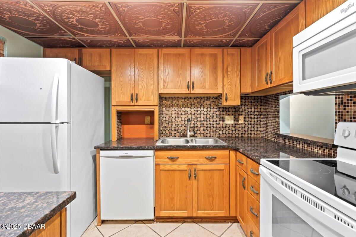 640 North Nova Road, Unit 114 Ormond Beach, FL 32174 - Photo 5 of 40 a kitchen with stainless steel appliances granite countertop a refrigerator and a sink