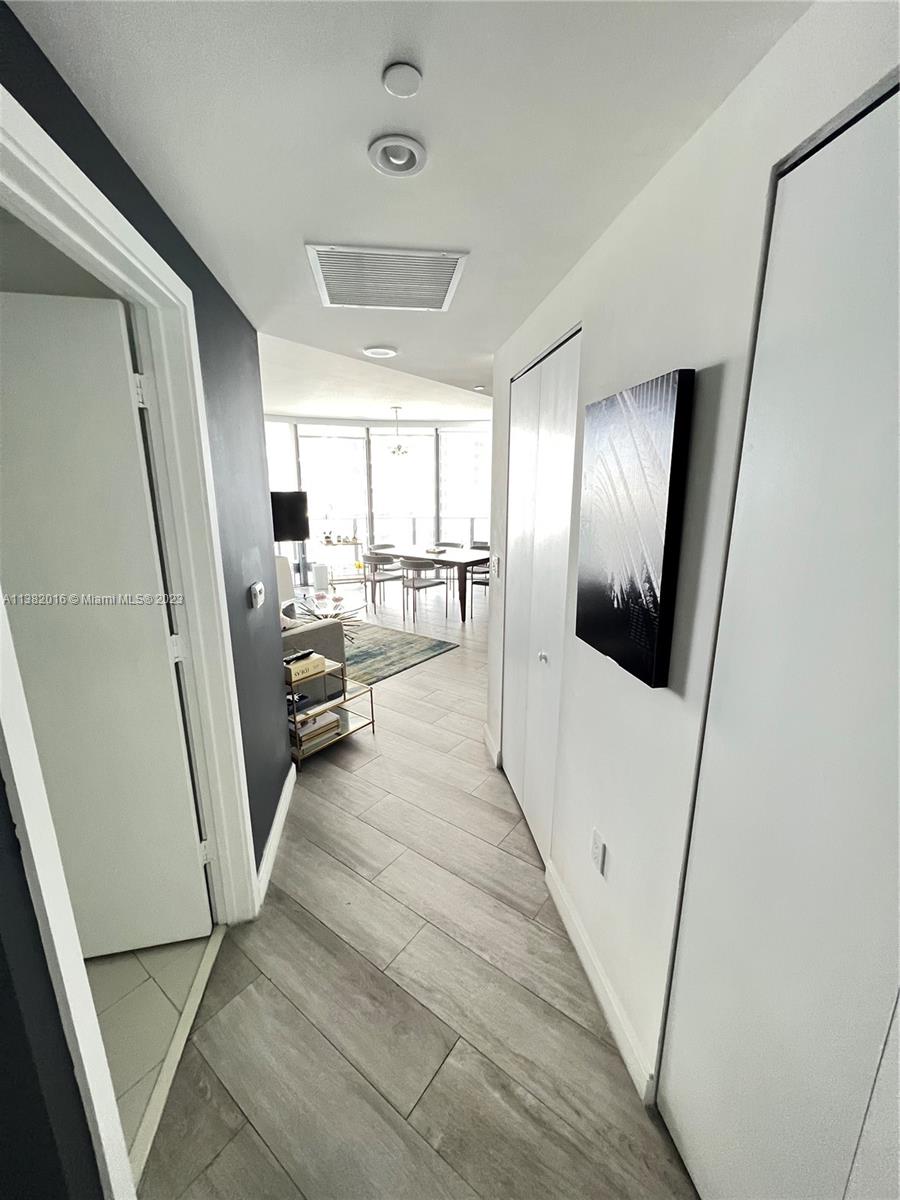 45 Southwest 9th Street, Unit 1908 Miami, FL 33130 - Photo 18 of 51 a view of a hallway with wooden floor and furniture