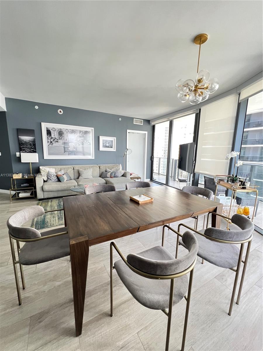 45 Southwest 9th Street, Unit 1908 Miami, FL 33130 - Photo 26 of 51 a living room with furniture a rug and a chandelier