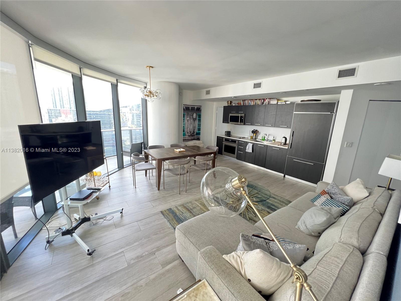 45 Southwest 9th Street, Unit 1908 Miami, FL 33130 - Photo 28 of 51 a living room with furniture or couch and a table