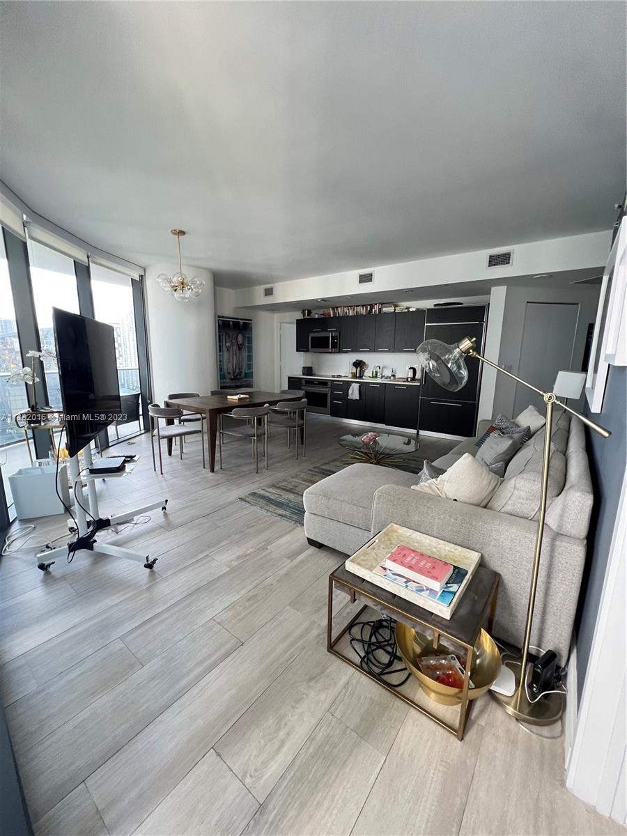 45 Southwest 9th Street, Unit 1908 Miami, FL 33130 - Photo 30 of 51 a living room with furniture and a flat screen tv