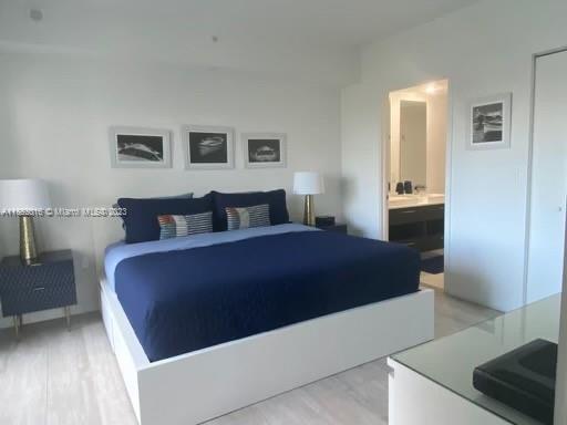 45 Southwest 9th Street, Unit 1908 Miami, FL 33130 - Photo 35 of 51 a bedroom with a bed and a lamp