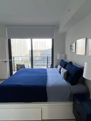 45 Southwest 9th Street, Unit 1908 Miami, FL 33130 - Photo 36 of 51 a bedroom with a bed and a window