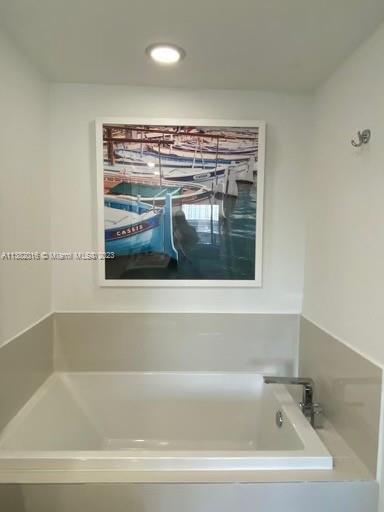 45 Southwest 9th Street, Unit 1908 Miami, FL 33130 - Photo 38 of 51 a bathroom with bathtub and window