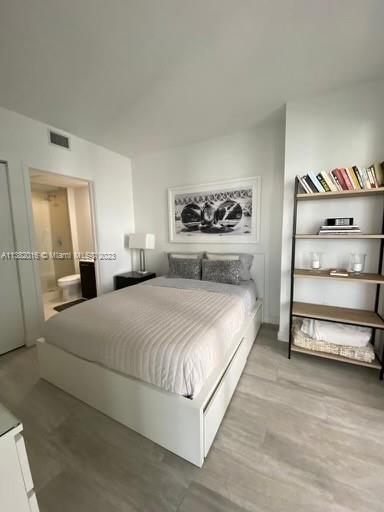 45 Southwest 9th Street, Unit 1908 Miami, FL 33130 - Photo 39 of 51 a bedroom with a bed and a cabinets