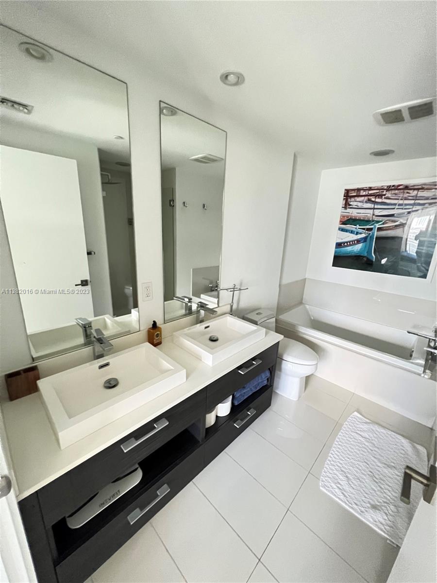 45 Southwest 9th Street, Unit 1908 Miami, FL 33130 - Photo 43 of 51 a bathroom with a double vanity sink and a mirror