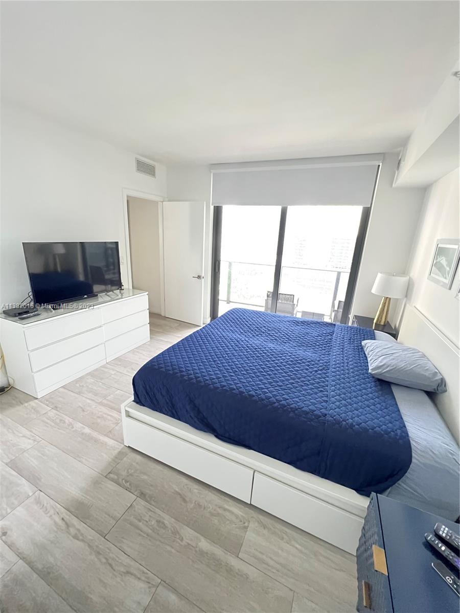 45 Southwest 9th Street, Unit 1908 Miami, FL 33130 - Photo 44 of 51 a large bed sitting in a bedroom and next to a window