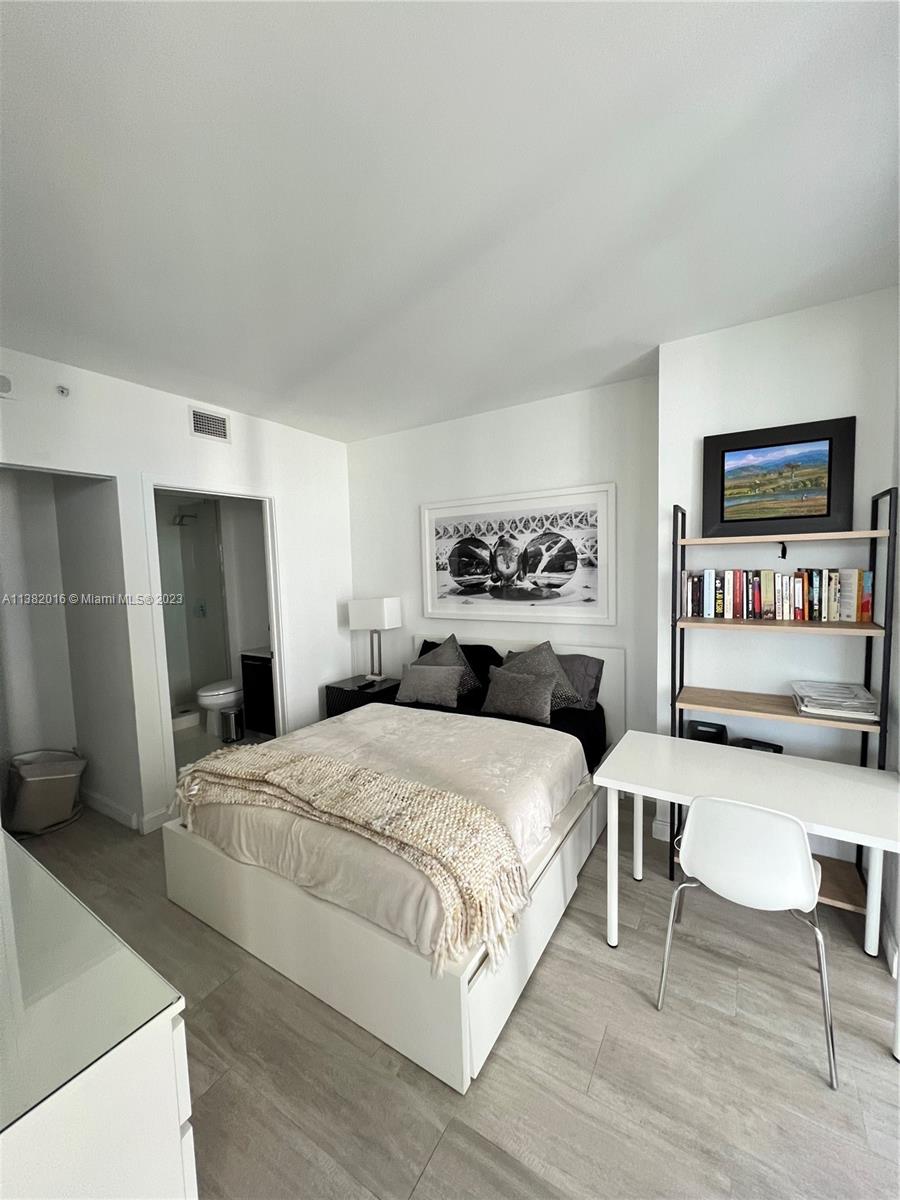 45 Southwest 9th Street, Unit 1908 Miami, FL 33130 - Photo 48 of 51 a bedroom with a bed and a desk