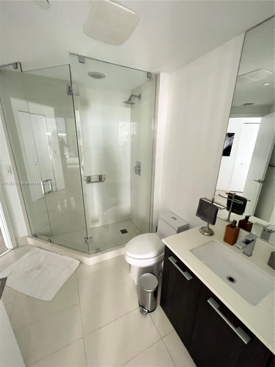 45 Southwest 9th Street, Unit 1908 Miami, FL 33130 - Photo 49 of 51 a bathroom with a sink a toilet and shower