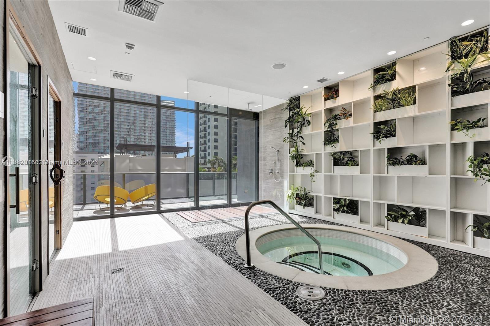 45 Southwest 9th Street, Unit 1908 Miami, FL 33130 - Photo 8 of 51 a swimming pool with a glass door