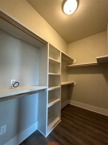 a view of a room with wooden floor