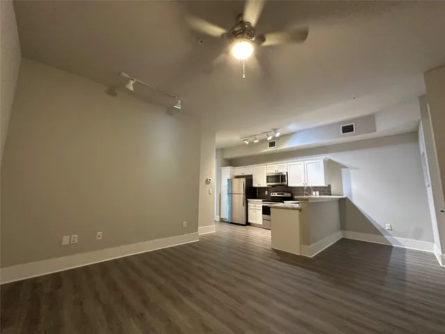 a kitchen with stove and cabinets