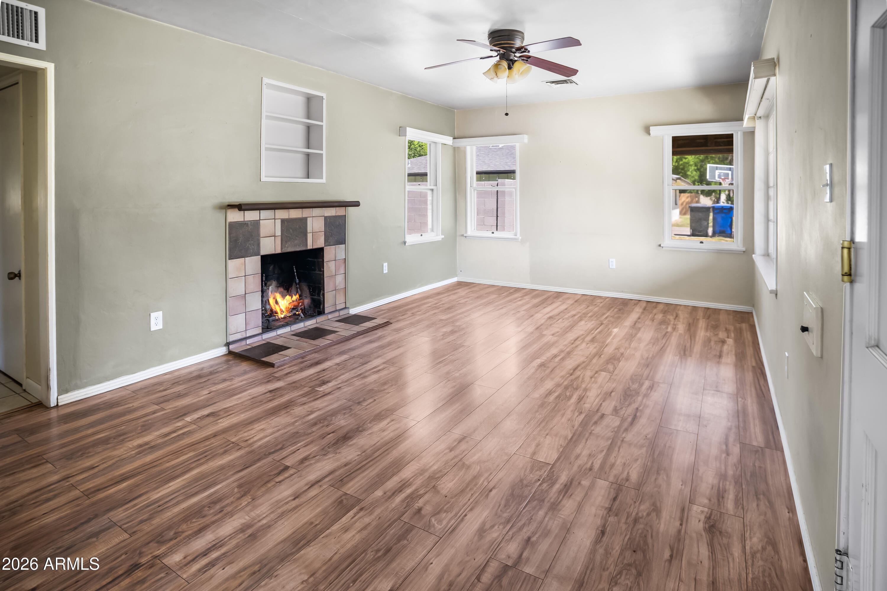 508 North Robson Mesa, AZ 85201 - Photo 2 of 19 a view of an empty room with wooden floor fireplace and a window