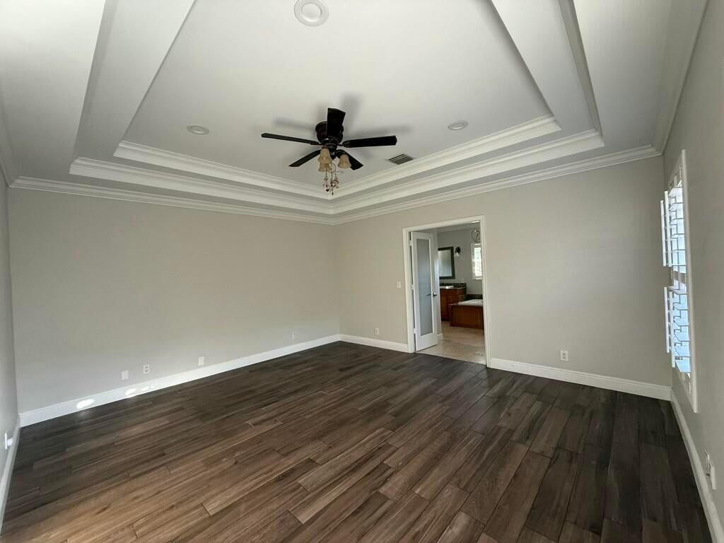 5777 Wind Drift Lane Boca Raton, FL 33433 - Photo 4 of 15 wooden floor in an empty room with a window