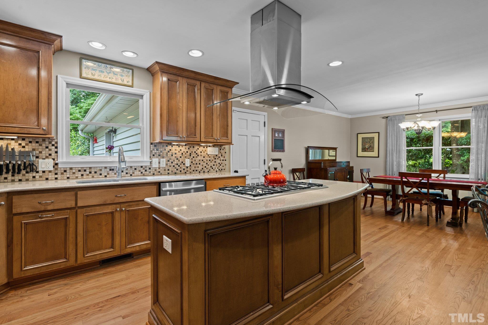 4116 Spruce Drive Raleigh, NC 27612 - Photo 11 of 51 a kitchen with stainless steel appliances granite countertop a sink a stove and a refrigerator