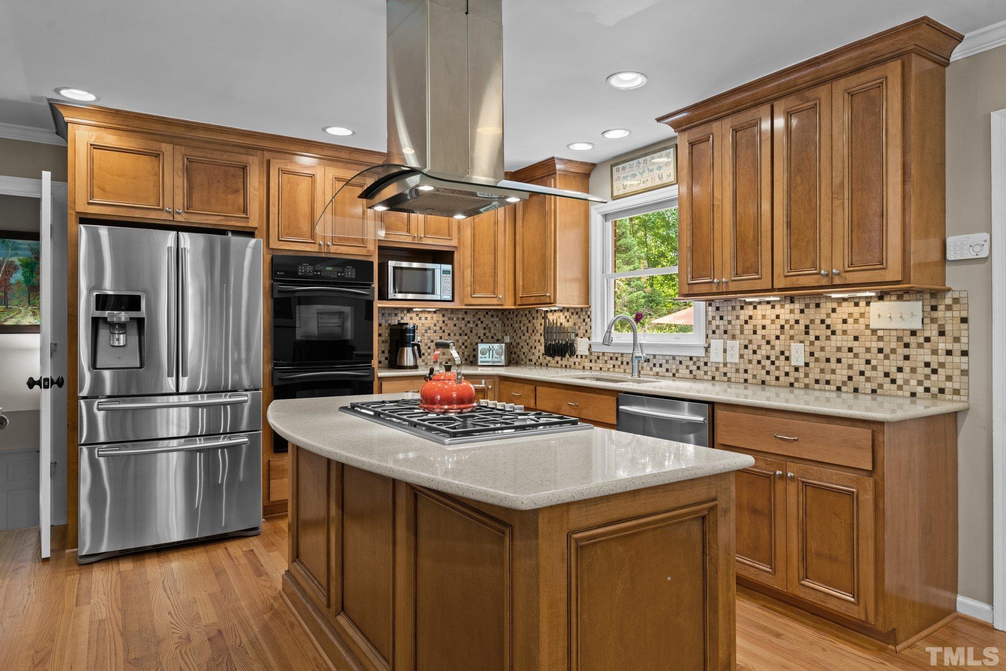 4116 Spruce Drive Raleigh, NC 27612 - Photo 13 of 51 a kitchen with stainless steel appliances granite countertop a sink stove and refrigerator