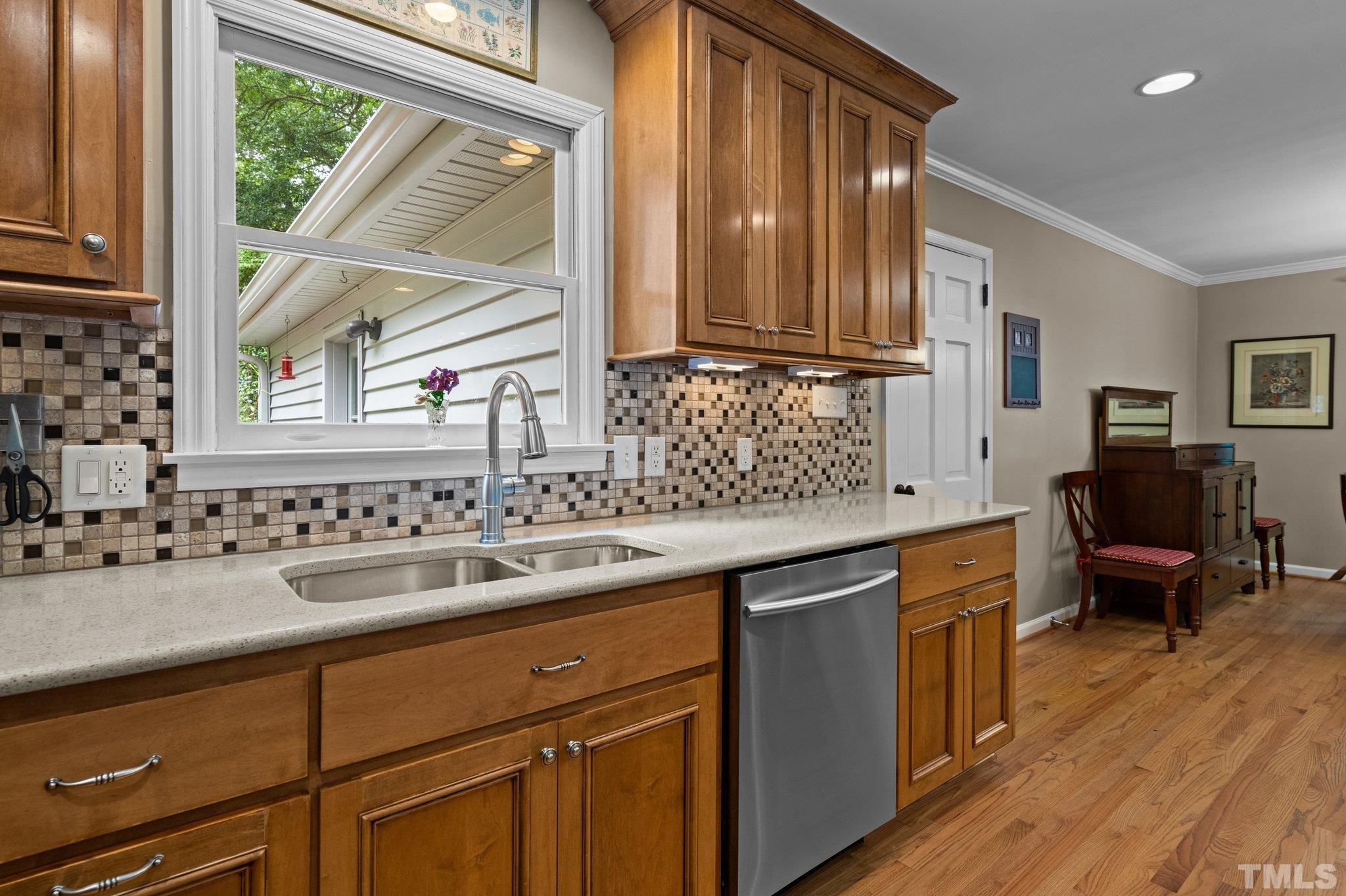 4116 Spruce Drive Raleigh, NC 27612 - Photo 14 of 51 a kitchen with a sink cabinets and wooden floor
