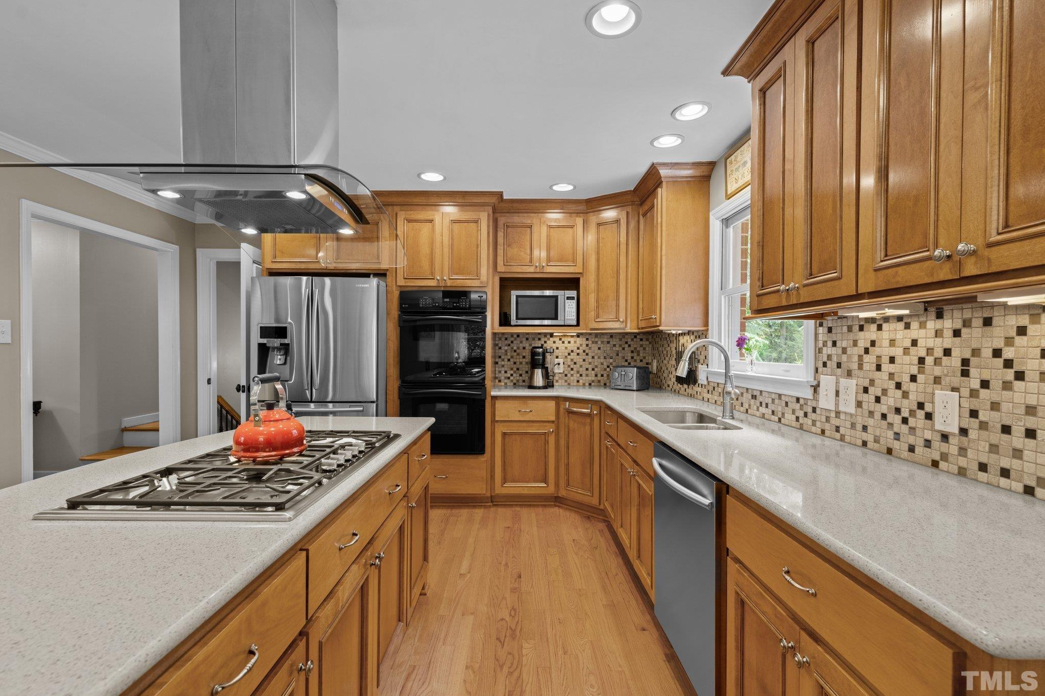 4116 Spruce Drive Raleigh, NC 27612 - Photo 15 of 51 a kitchen with stainless steel appliances granite countertop a refrigerator and a stove top oven