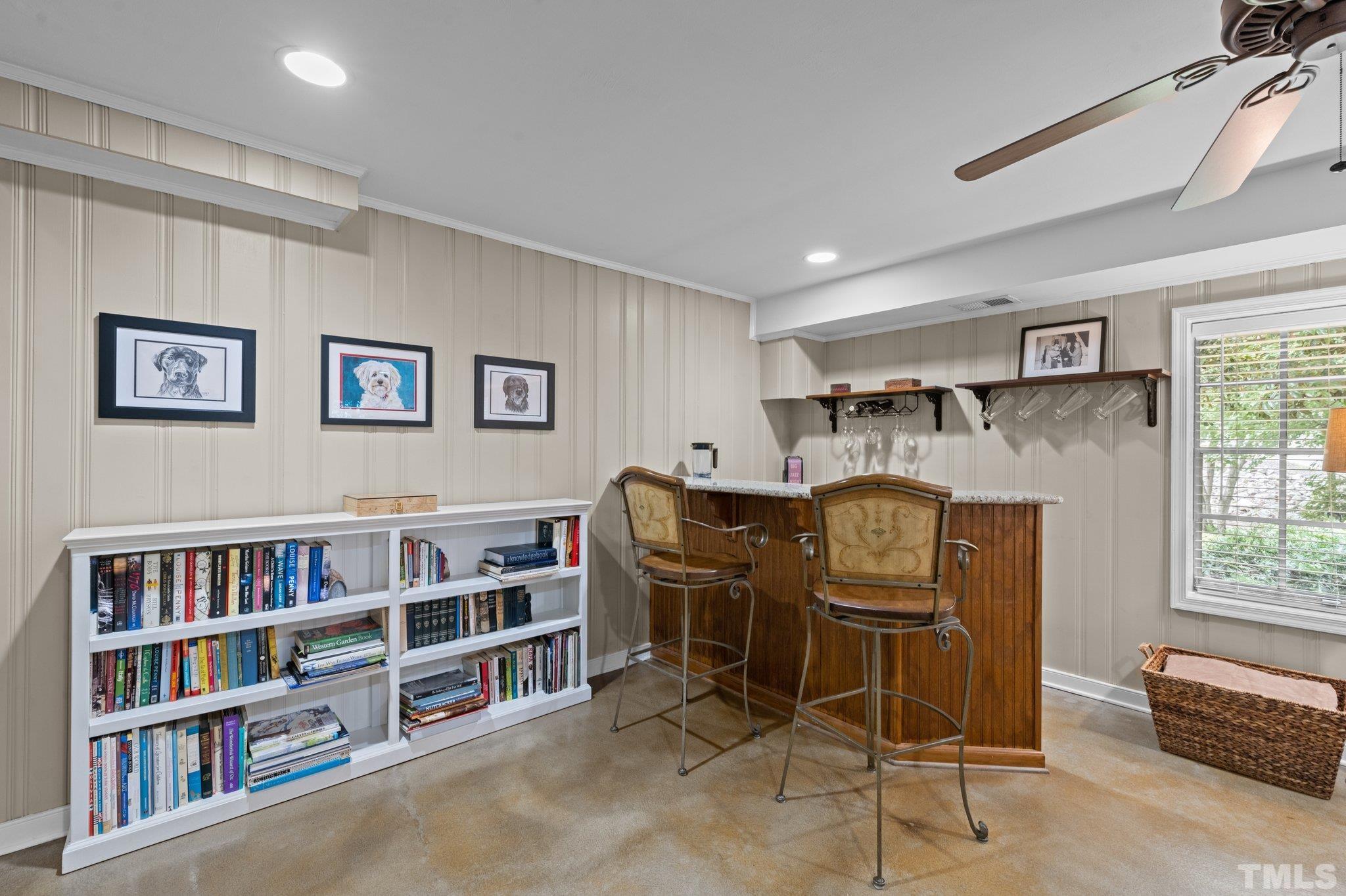4116 Spruce Drive Raleigh, NC 27612 - Photo 19 of 51 a work room with furniture a bookshelf and a bookshelf