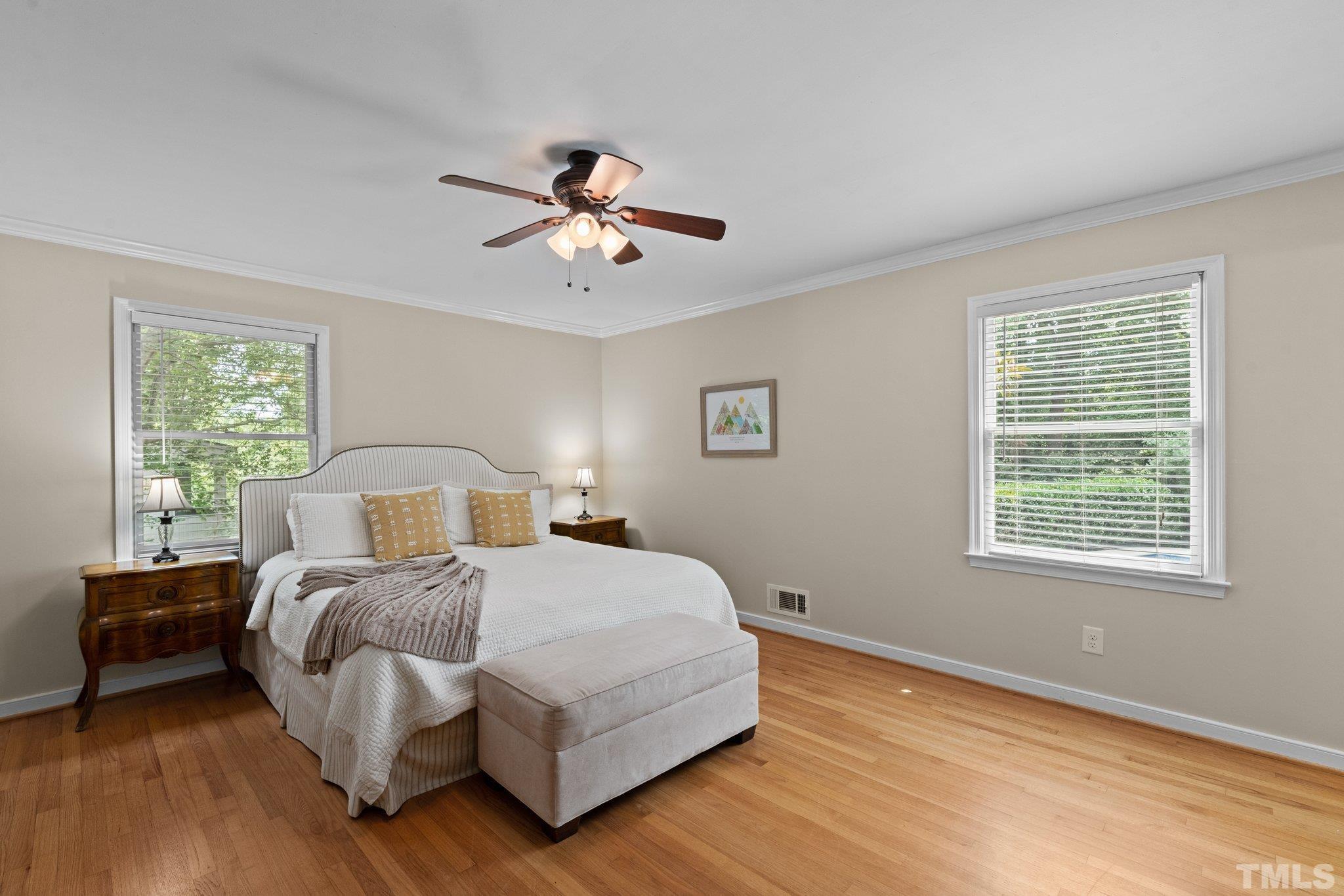 4116 Spruce Drive Raleigh, NC 27612 - Photo 23 of 51 a bedroom with a bed chandelier and a window