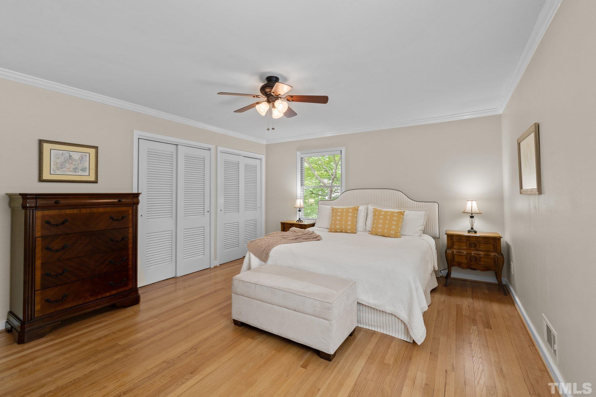 4116 Spruce Drive Raleigh, NC 27612 - Photo 24 of 51 a spacious bedroom with a bed and a chandelier