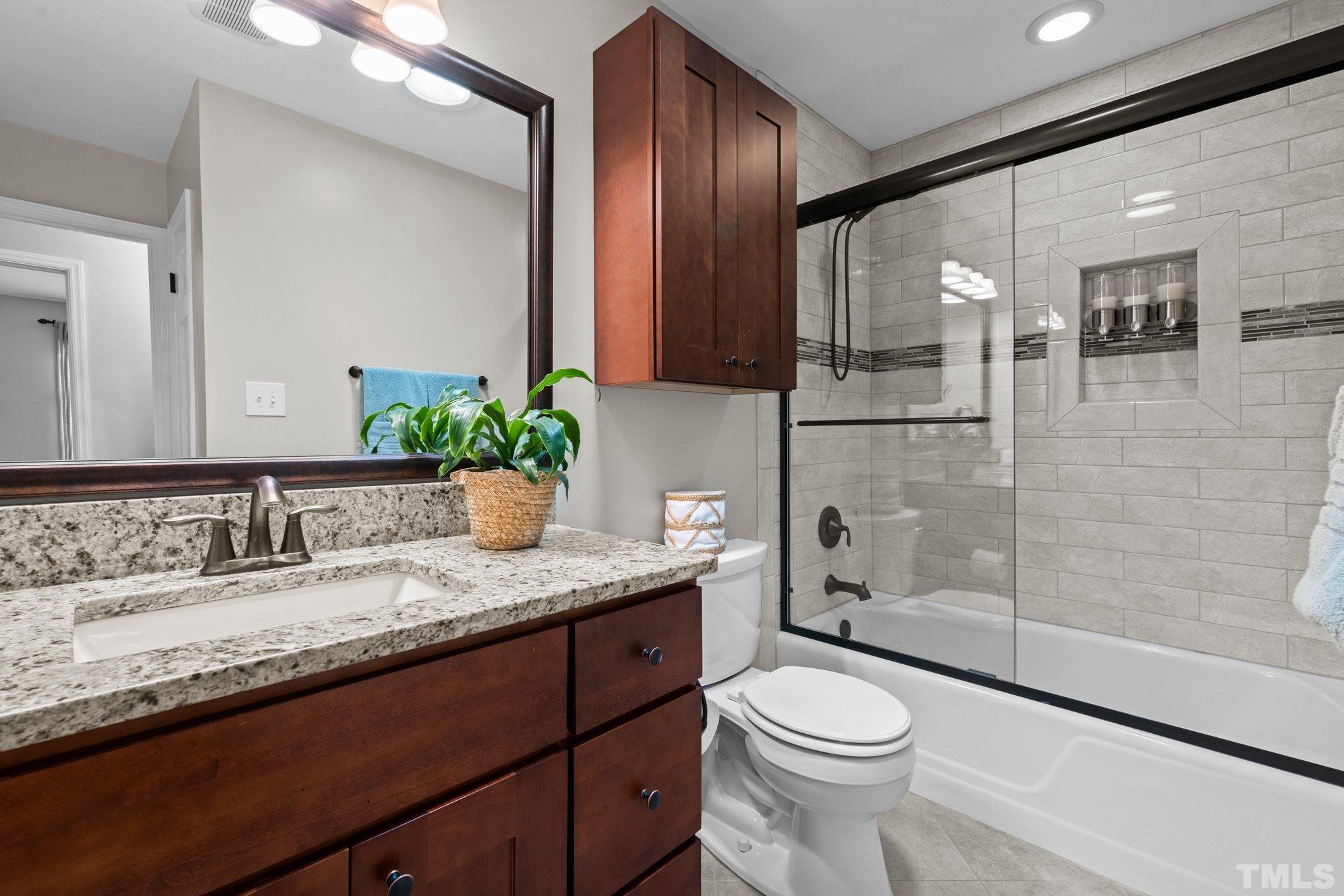4116 Spruce Drive Raleigh, NC 27612 - Photo 27 of 51 a bathroom with a granite countertop sink toilet and shower