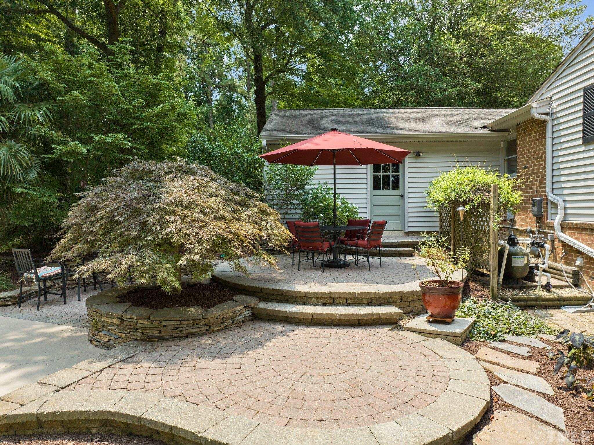 4116 Spruce Drive Raleigh, NC 27612 - Photo 42 of 51 a view of a patio with table and chairs under an umbrella