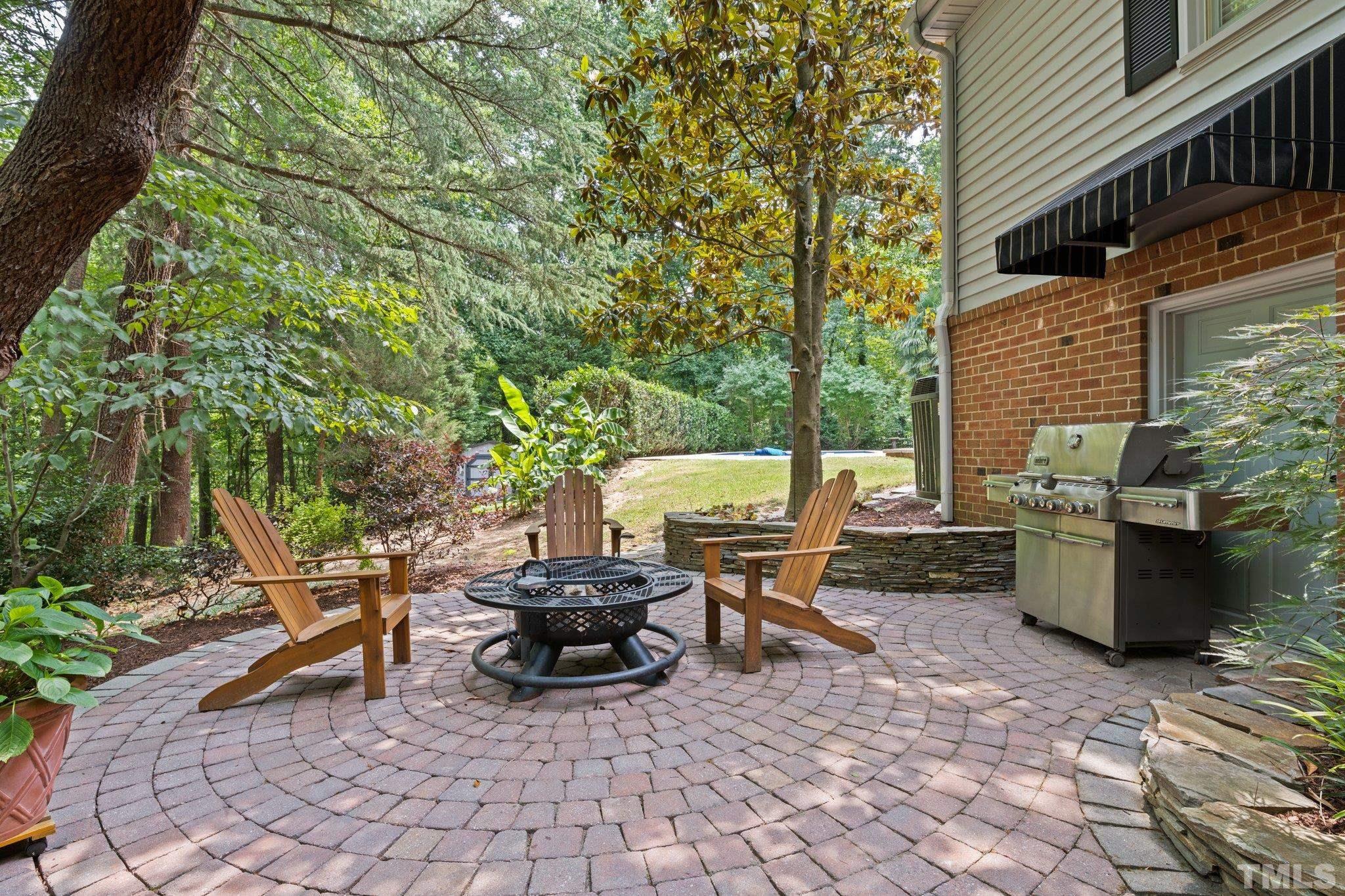 4116 Spruce Drive Raleigh, NC 27612 - Photo 46 of 51 a view of a patio with table and chairs and potted plants