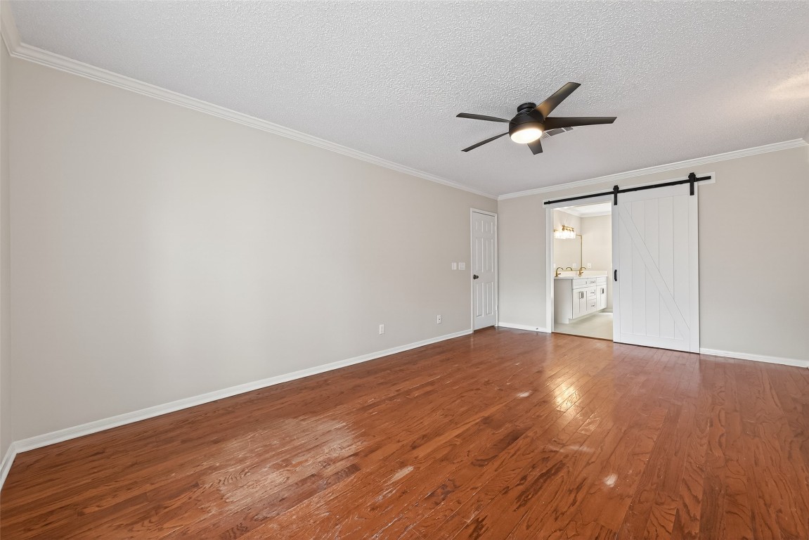 106 Breezy Point Place Spring, TX 77381 - Photo 18 of 37 Private first-floor primary suite features generous space and sliding door access.