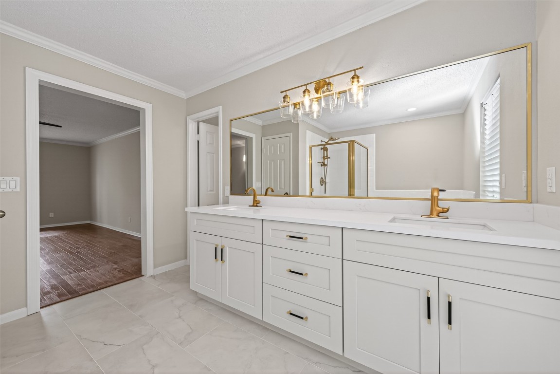 106 Breezy Point Place Spring, TX 77381 - Photo 19 of 37 Remodeled primary bathroom showcases elegant gold fixtures and stylish finishes.